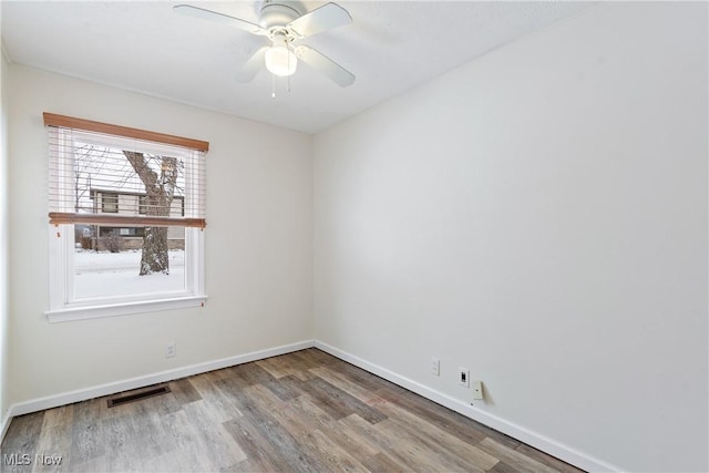 empty room featuring hardwood / wood-style floors and ceiling fan