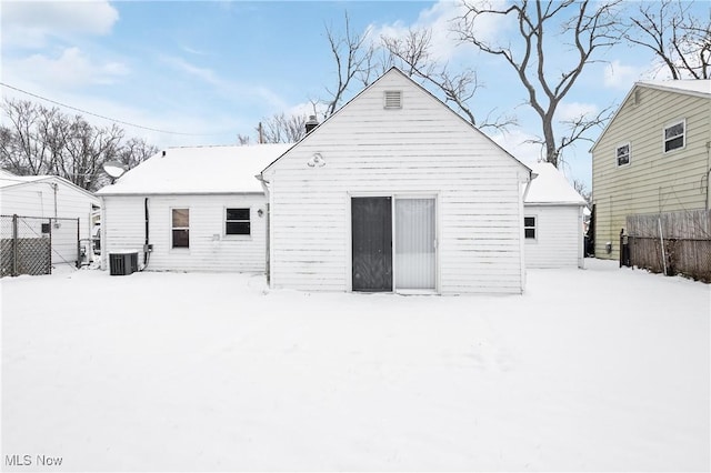 snow covered property featuring central AC unit