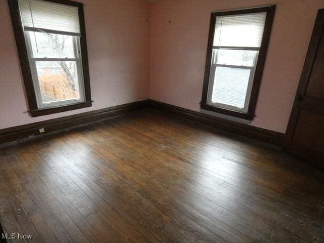 unfurnished room with dark hardwood / wood-style floors