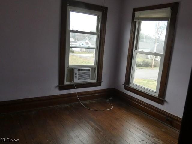 empty room featuring cooling unit and hardwood / wood-style flooring