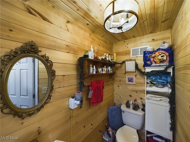 bathroom with wood walls and wood ceiling