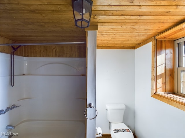 bathroom featuring a healthy amount of sunlight, toilet, and wooden ceiling