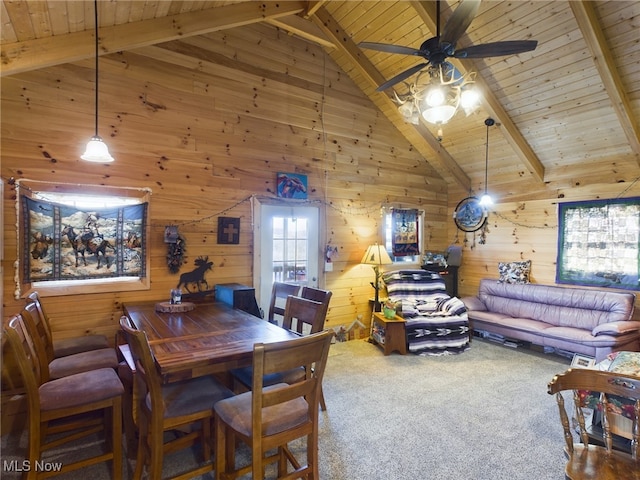 dining area featuring carpet, wood walls, beamed ceiling, and wooden ceiling