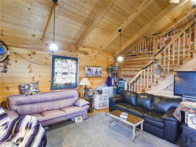 carpeted living room with beam ceiling, wood walls, high vaulted ceiling, and wood ceiling