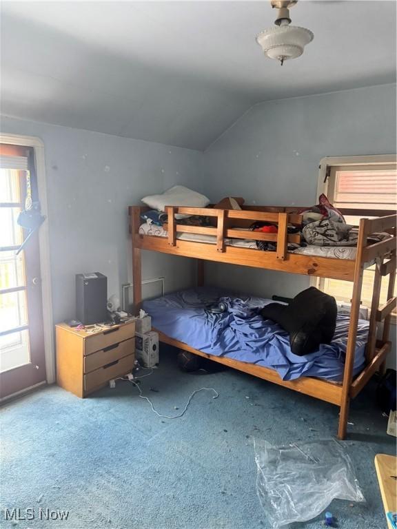 carpeted bedroom with vaulted ceiling