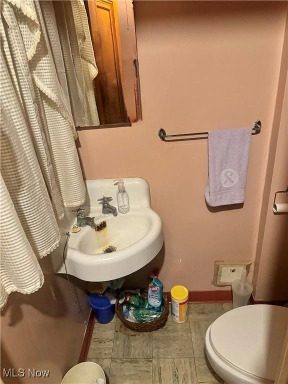 bathroom with toilet and sink