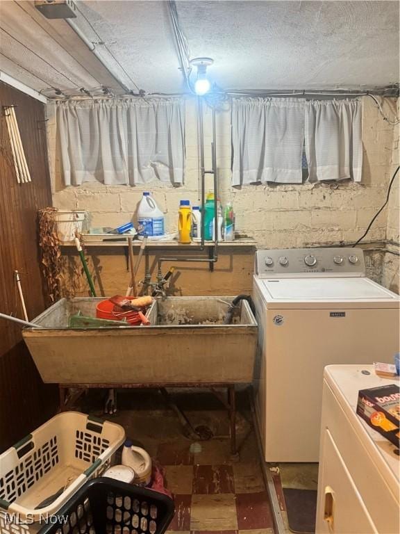 washroom with washer and clothes dryer and sink