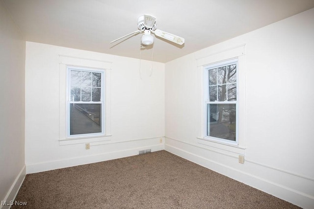 unfurnished room featuring ceiling fan and carpet floors