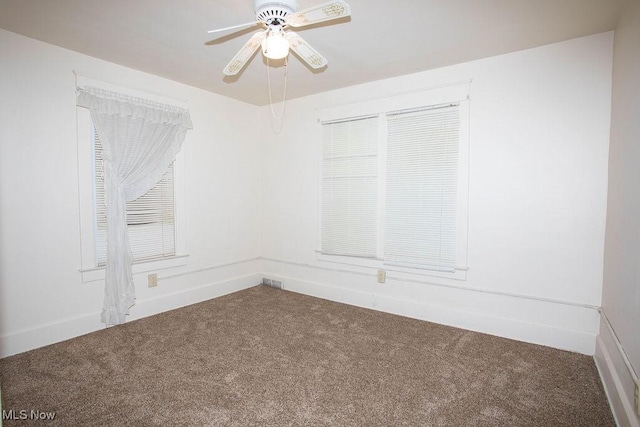 unfurnished room featuring ceiling fan and carpet floors