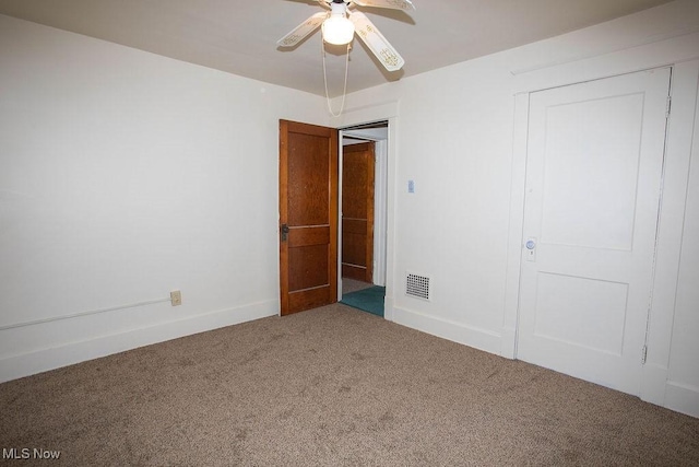 unfurnished bedroom with carpet flooring, ceiling fan, and a closet