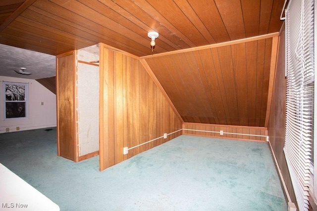 bonus room with carpet flooring, wooden walls, and wood ceiling