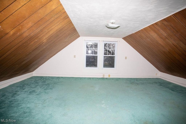 bonus room featuring carpet flooring and a textured ceiling