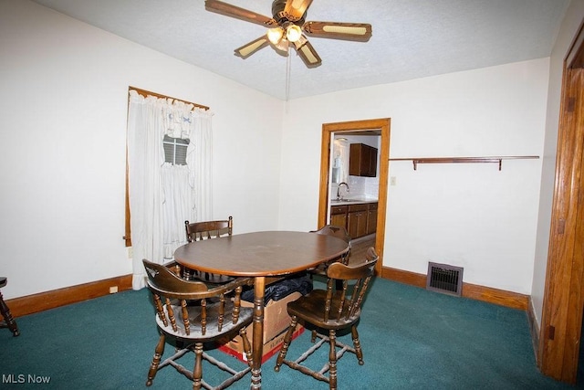 carpeted dining area featuring ceiling fan and sink