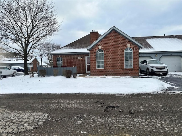 view of snowy exterior featuring a garage