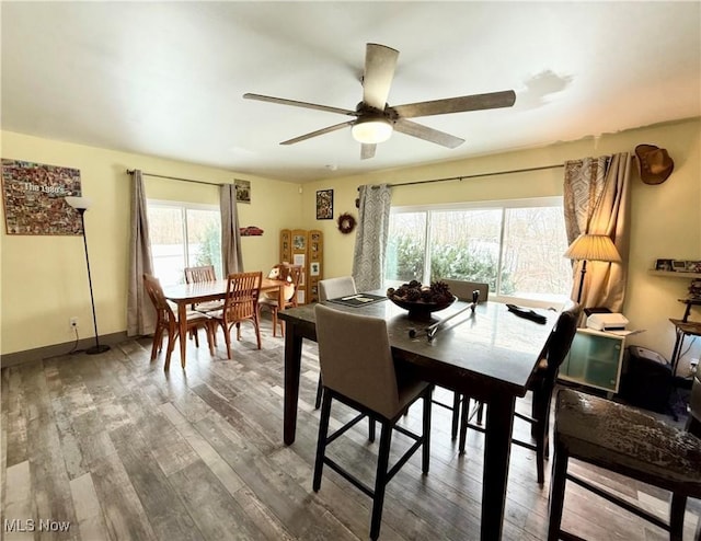 dining area featuring wood-type flooring and ceiling fan