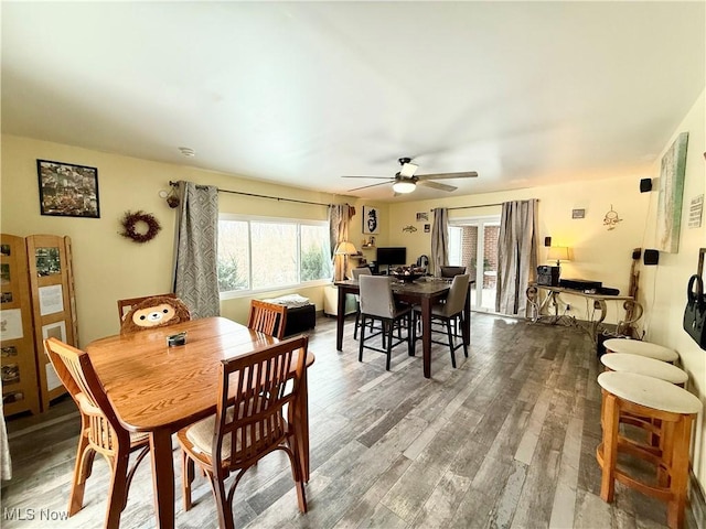 dining area featuring wood-type flooring and ceiling fan