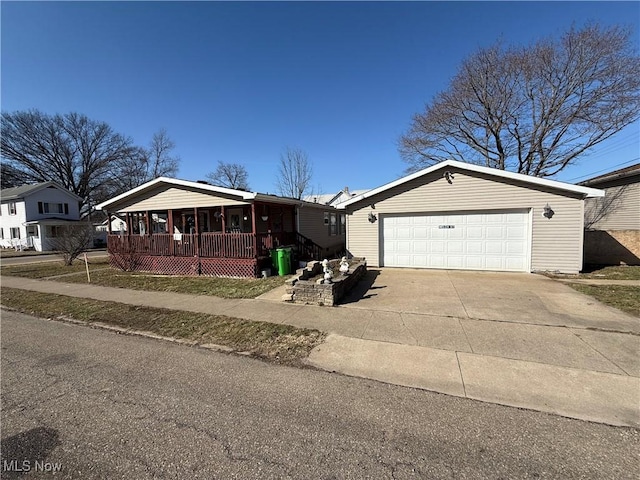 view of front of property featuring covered porch, an attached garage, and concrete driveway