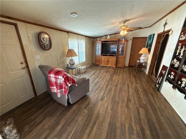 living room with a textured ceiling, wood finished floors, crown molding, and vaulted ceiling