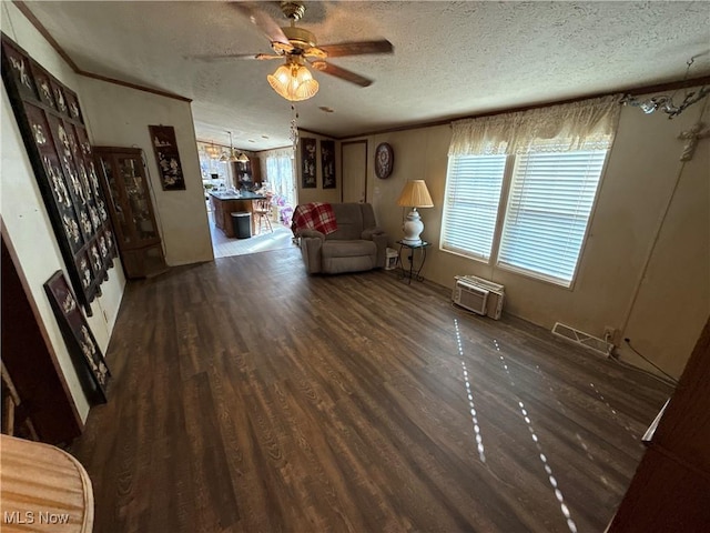 unfurnished living room with ornamental molding, a textured ceiling, a ceiling fan, and wood finished floors