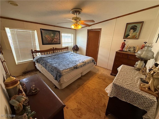 bedroom featuring crown molding, a ceiling fan, and a textured ceiling