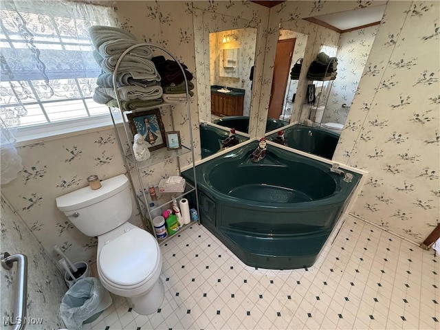 bathroom with tile patterned floors, toilet, wallpapered walls, and vanity