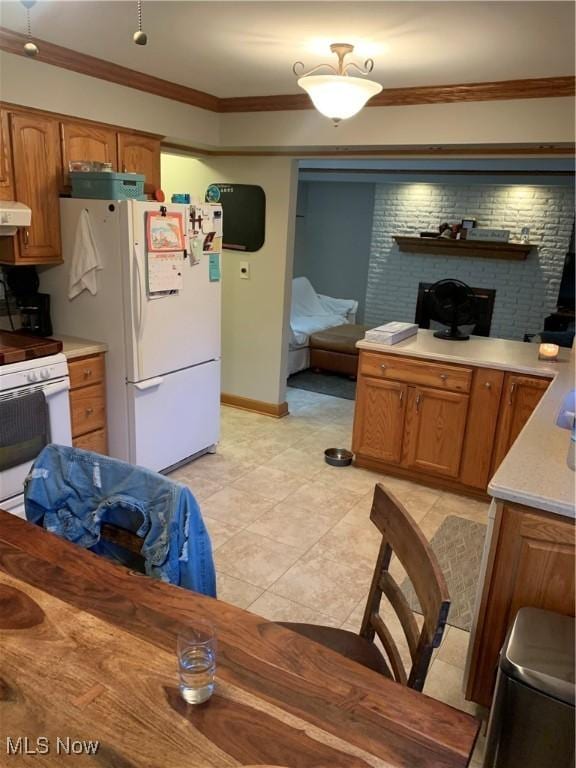 kitchen featuring ventilation hood, white appliances, and ornamental molding