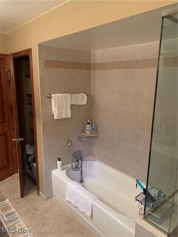 bathroom with tile patterned flooring and separate shower and tub