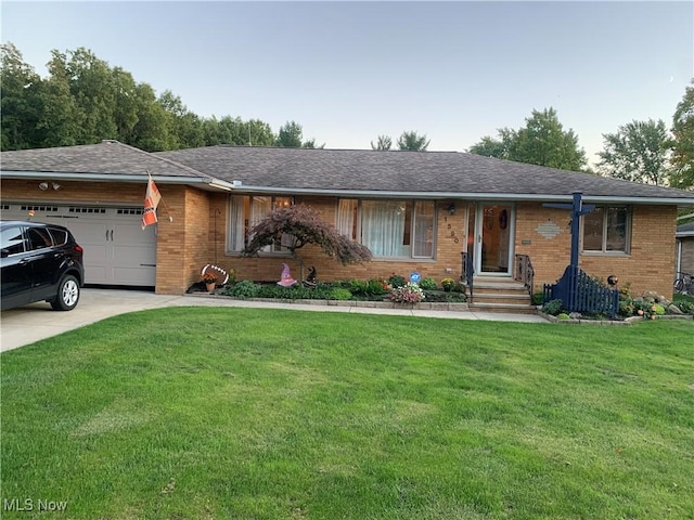 ranch-style house featuring a front yard and a garage