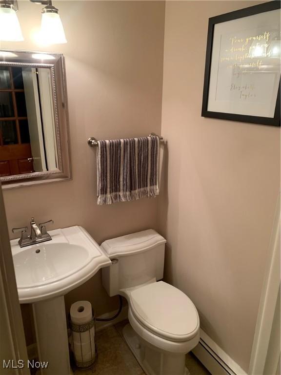 bathroom featuring toilet and baseboard heating