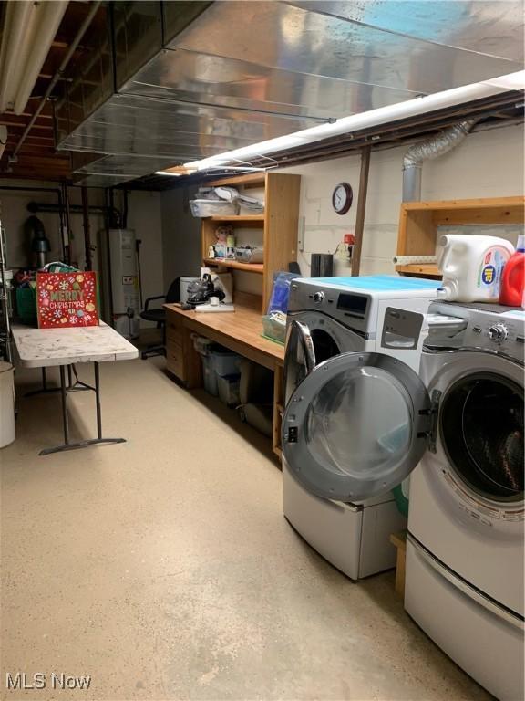 laundry area with washer and clothes dryer and water heater