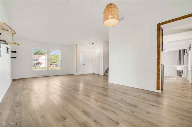 6301 Fiesta Ct, Lorain, OH 44053 - unfurnished living room featuring wood finished floors and stairway