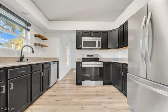 6301 Fiesta Ct, Lorain, OH 44053 - kitchen featuring stainless steel appliances, light countertops, light wood finished floors, and open shelves