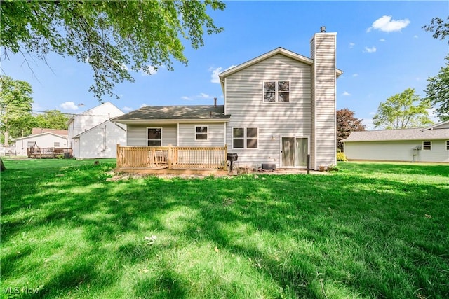 6301 Fiesta Ct, Lorain, OH 44053 - rear view of house with a chimney, a yard, and a wooden deck