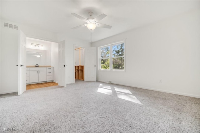6301 Fiesta Ct, Lorain, OH 44053 - unfurnished bedroom with light carpet, ensuite bathroom, and ceiling fan