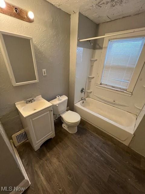 full bathroom with hardwood / wood-style floors, vanity, toilet, and shower / bathtub combination