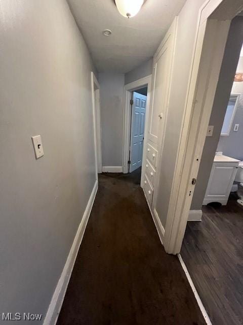 corridor with dark wood-type flooring