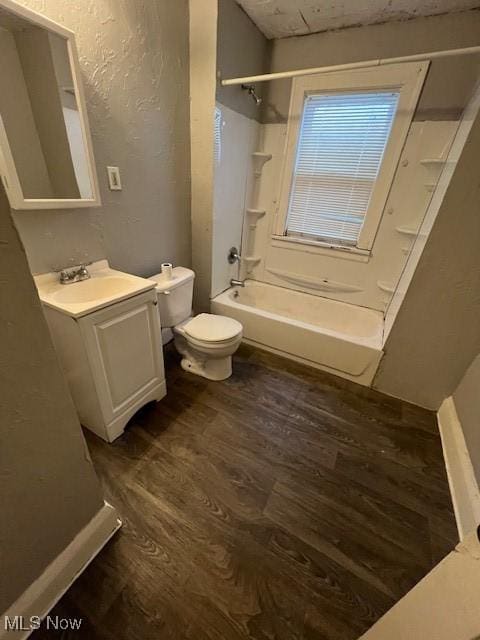 full bathroom with bathtub / shower combination, wood-type flooring, vanity, and toilet