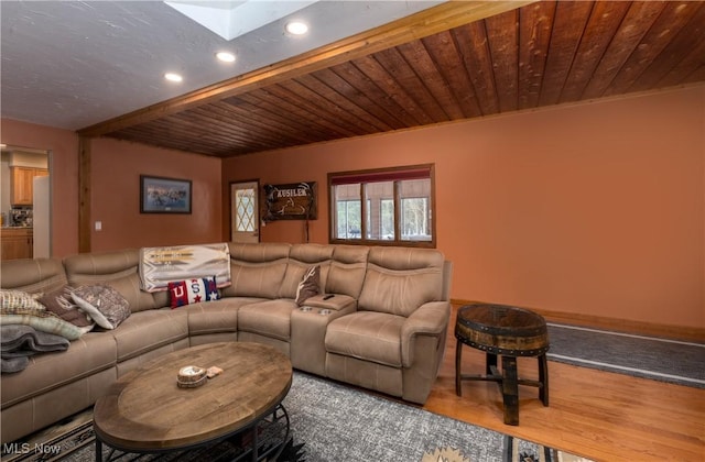 living room featuring beam ceiling, a skylight, wood ceiling, and wood-type flooring