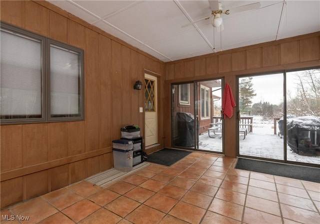 unfurnished sunroom featuring ceiling fan