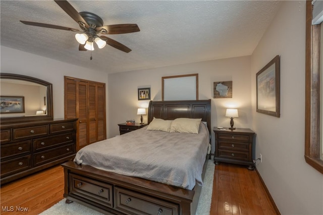 bedroom with a textured ceiling, a closet, and ceiling fan