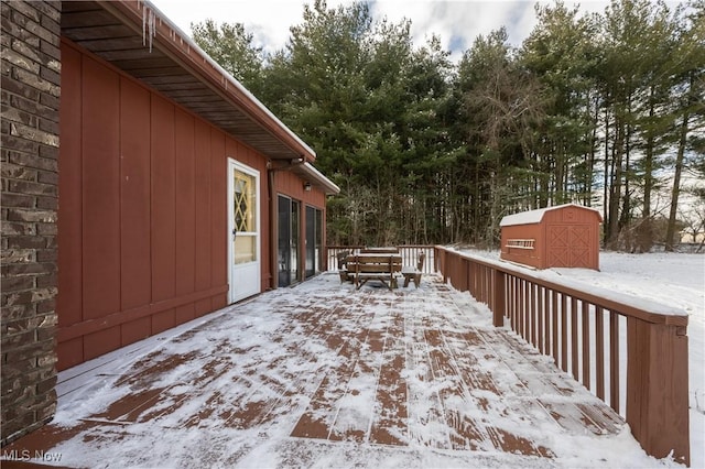 snow covered deck with a storage unit