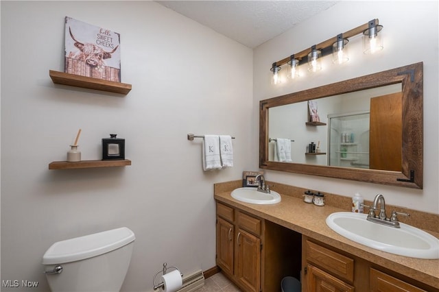 bathroom with tile patterned floors, vanity, a textured ceiling, and toilet