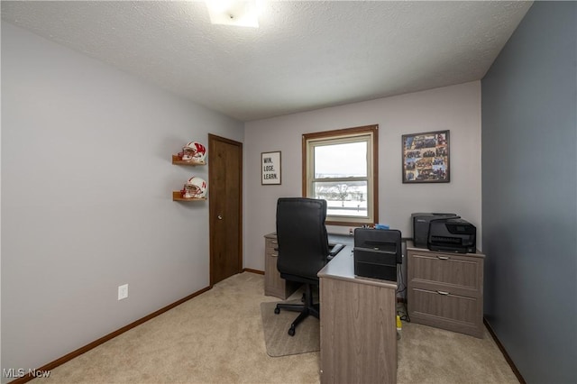 home office featuring light carpet and a textured ceiling