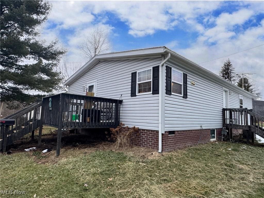 view of property exterior featuring a yard and crawl space