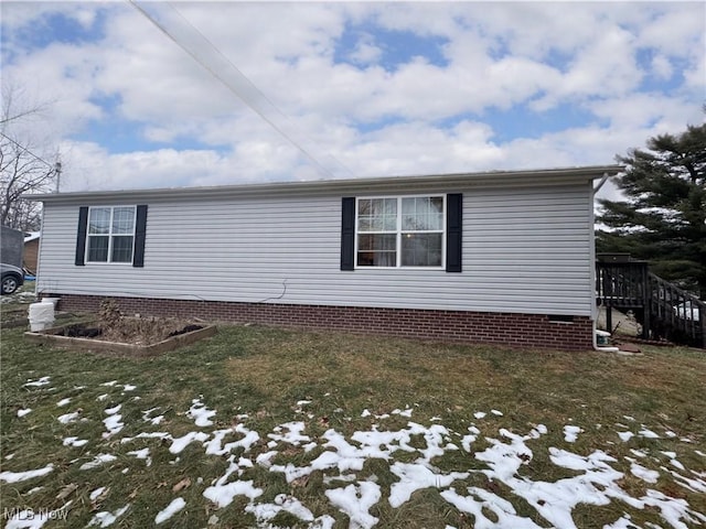 snow covered property featuring a lawn