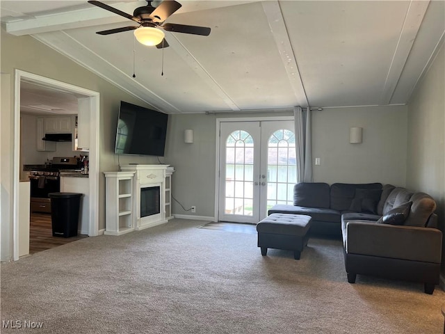 carpeted living room featuring lofted ceiling with beams, ceiling fan, and french doors