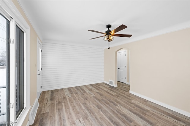 unfurnished room with ceiling fan and light wood-type flooring