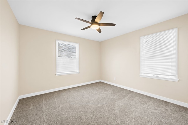 carpeted spare room with ceiling fan