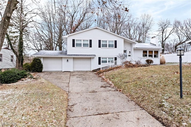 view of front of property featuring a garage and a front lawn