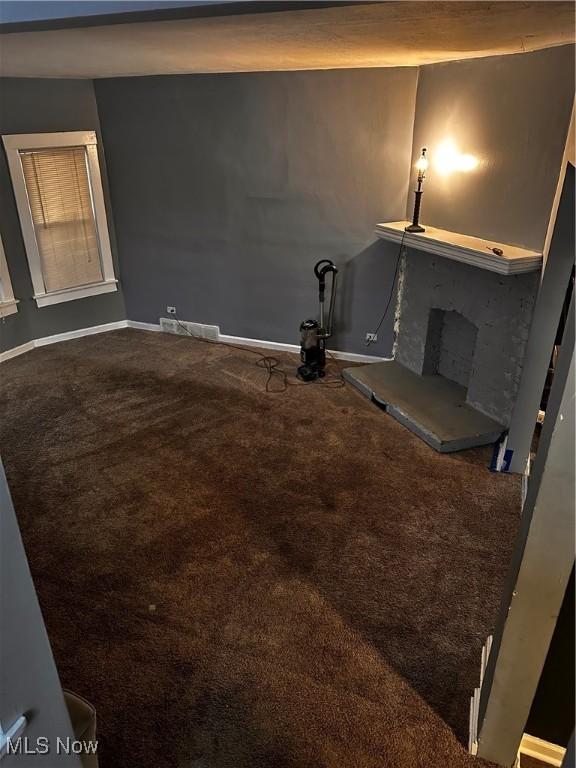 unfurnished living room featuring carpet flooring